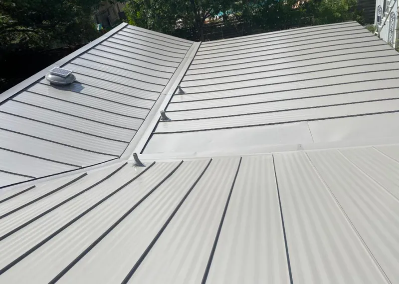 Solar attic fan installed on a metal roof for Roof Ventilation in Seffner